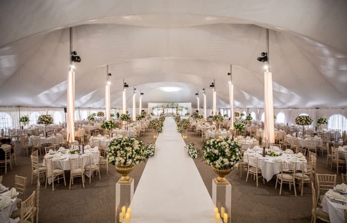 The Mega Marquee dressed for a wedding, a floral aisle running the length of the grand canvas